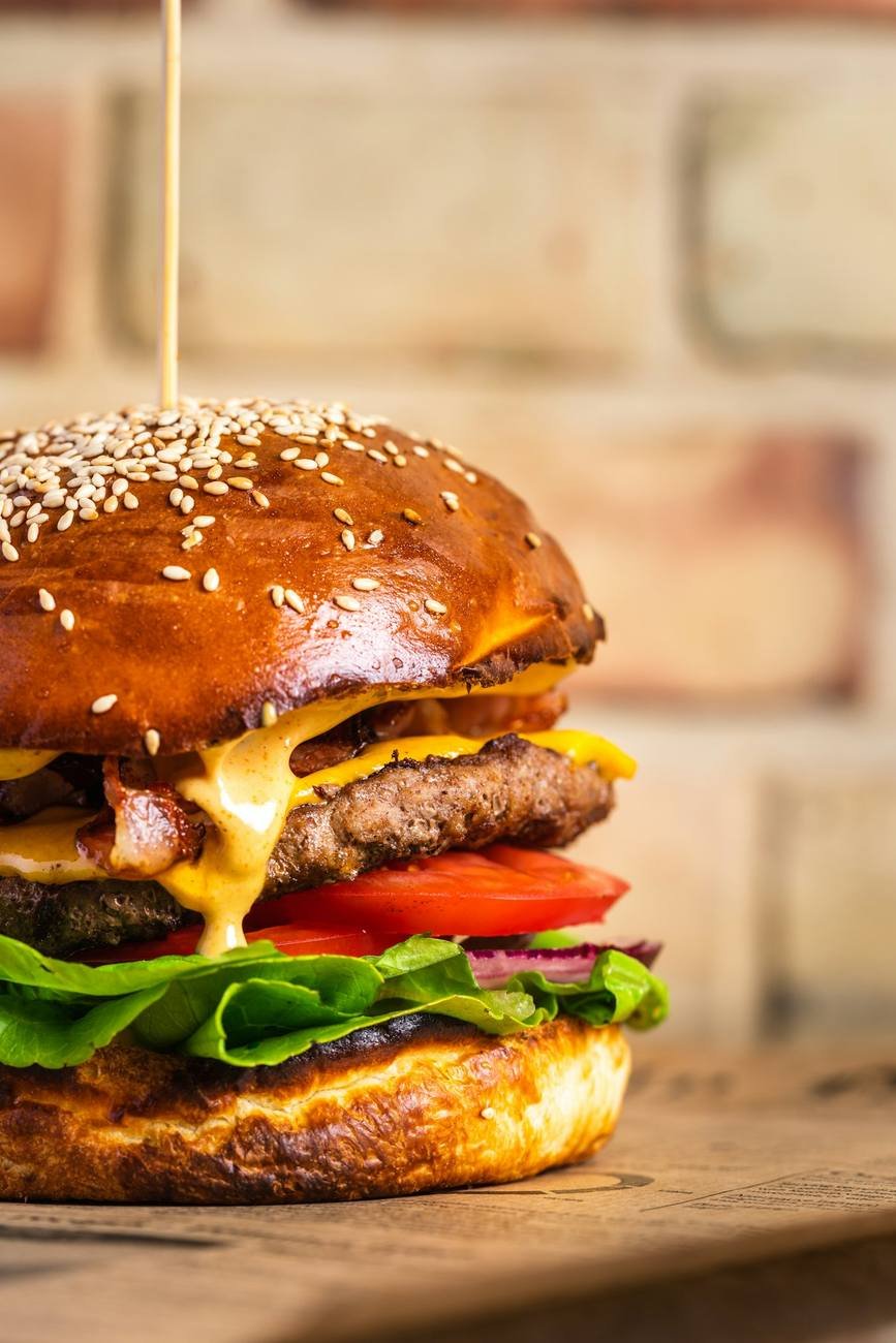 Chargrilled beef burger with melted cheese in a brioche bun