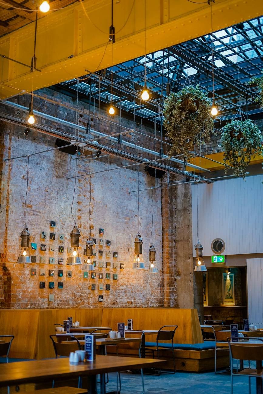The indoor dining hall with hanging lights and long shared tables