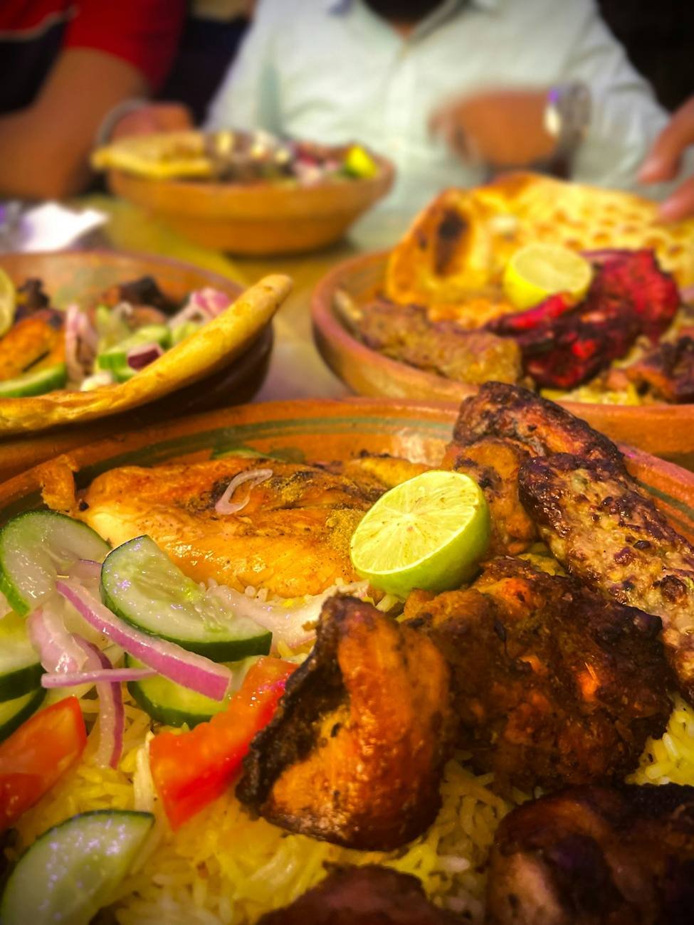 Whole roast chicken platter with lemon, salad and flatbread
